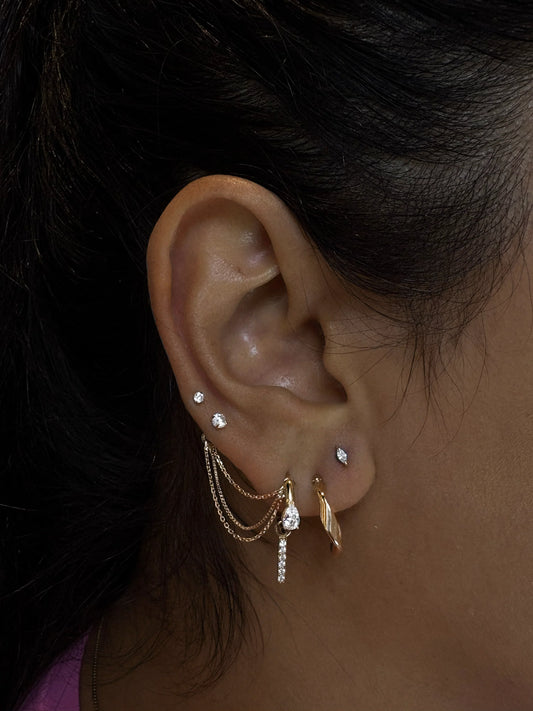 Ear Curation piercing styling session on Fatimah at Metalia Studios